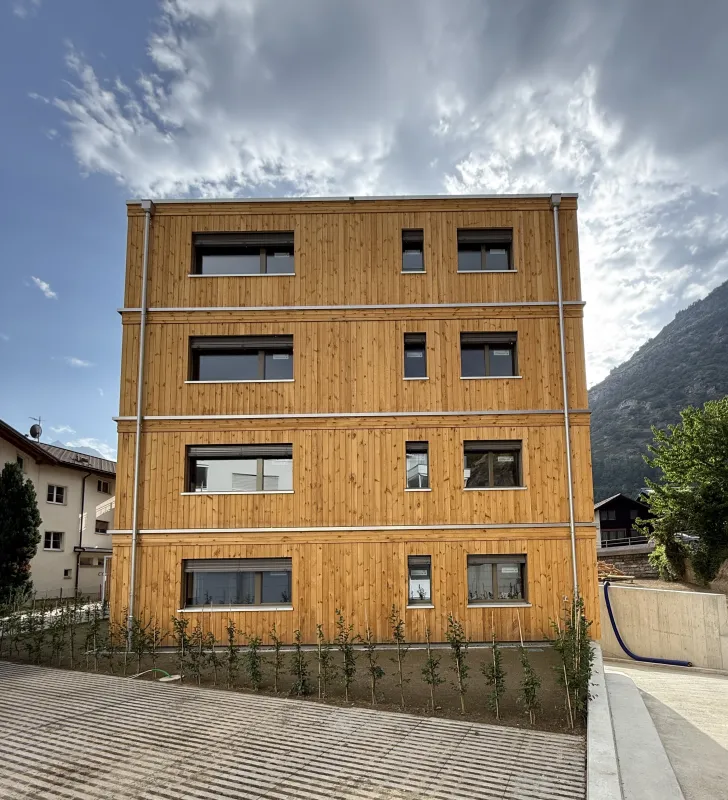 Mehrfamilienhaus in moderner Holzbauweise mit vier Geschossen, grosszügigen Balkonen und Holzfassade